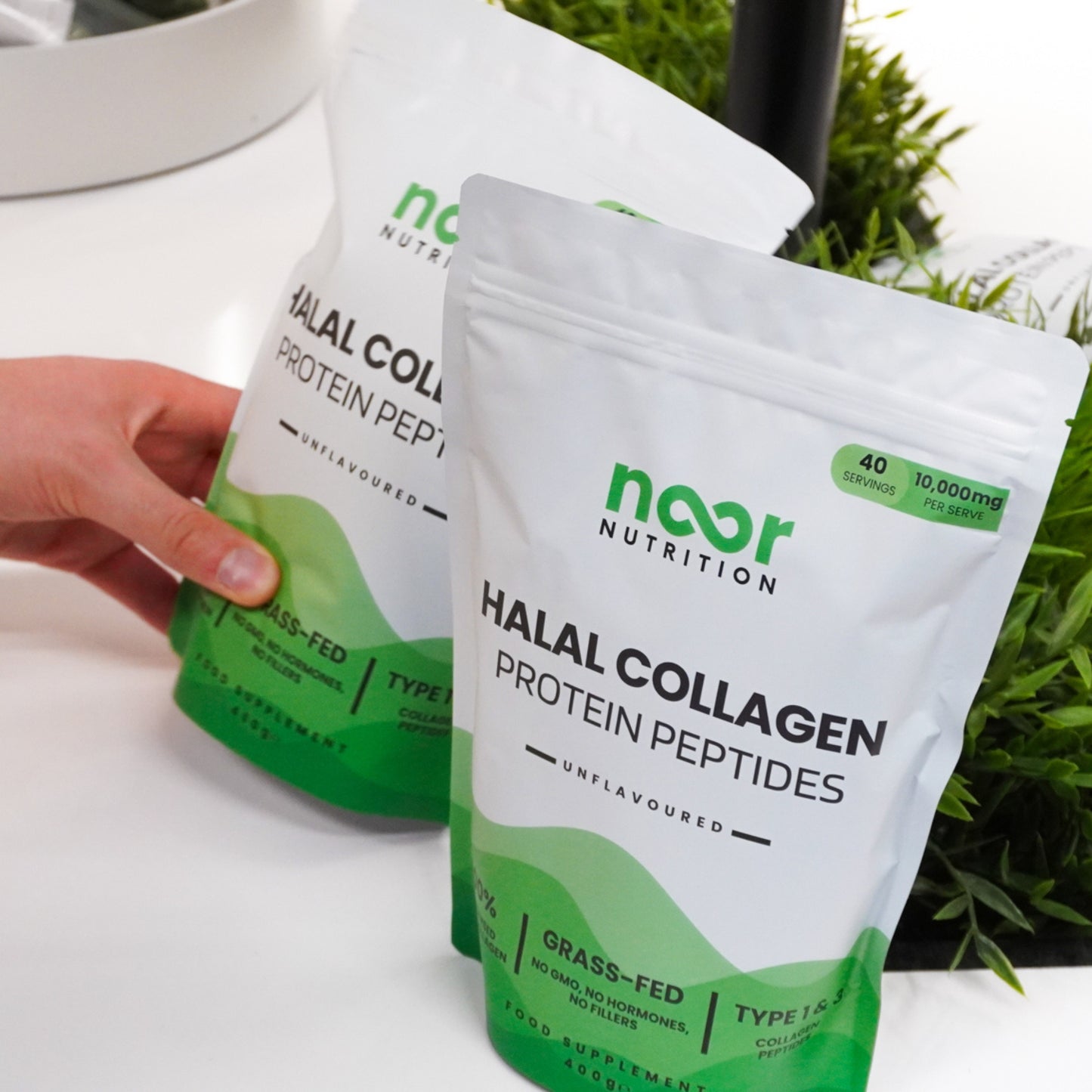 Two pouches of collagen powder on a table